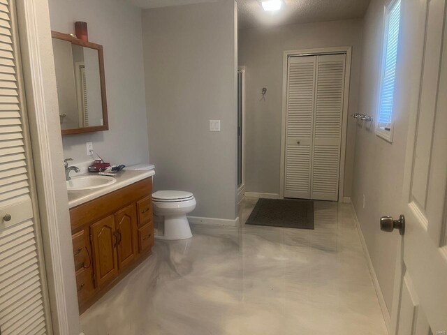 bathroom featuring tile flooring, toilet, and vanity