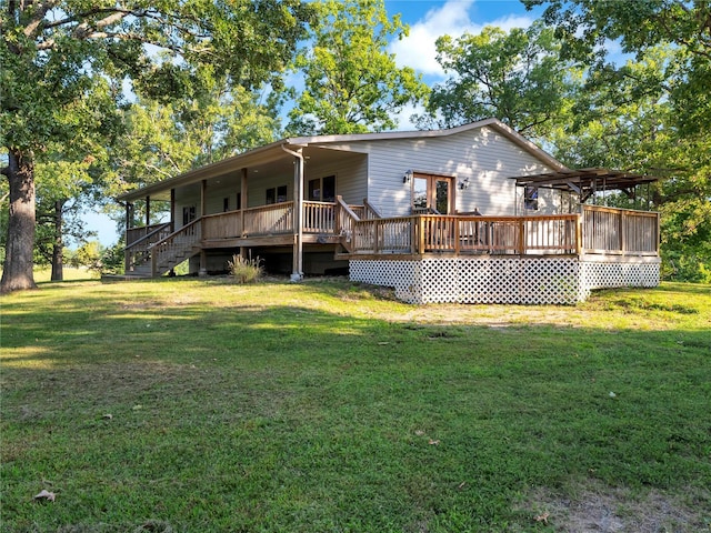 back of property featuring a lawn and a wooden deck