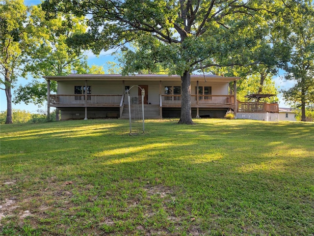 back of house with a yard and a deck