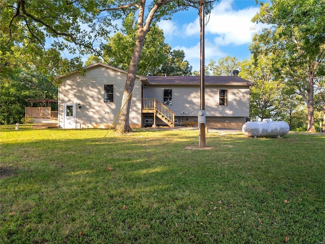 back of property with a lawn and a wooden deck