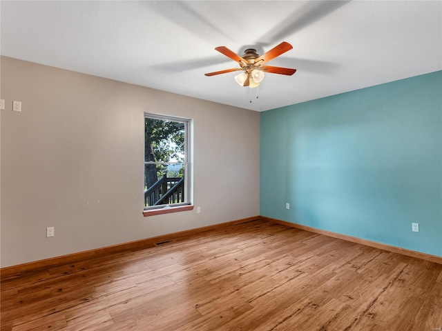 spare room featuring ceiling fan and light hardwood / wood-style flooring