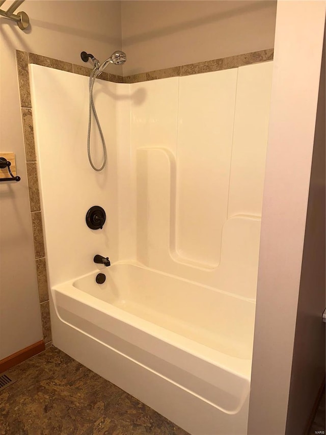 bathroom with tile patterned flooring and shower / washtub combination