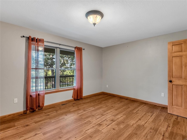 unfurnished room with light hardwood / wood-style floors