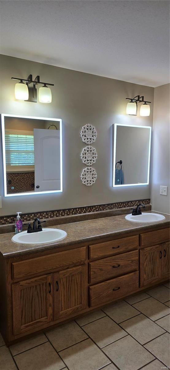 bathroom with dual vanity and tile patterned flooring