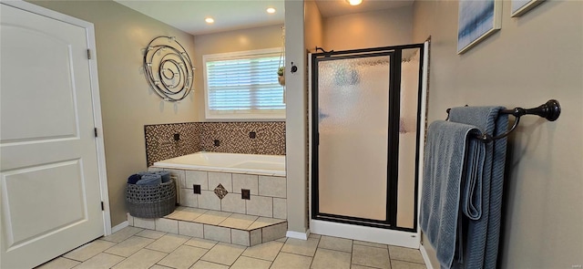 bathroom with independent shower and bath and tile patterned floors