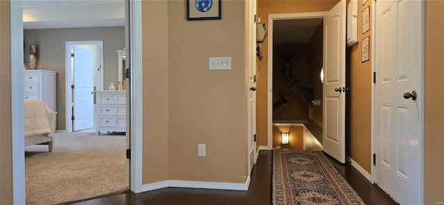 hallway featuring dark carpet