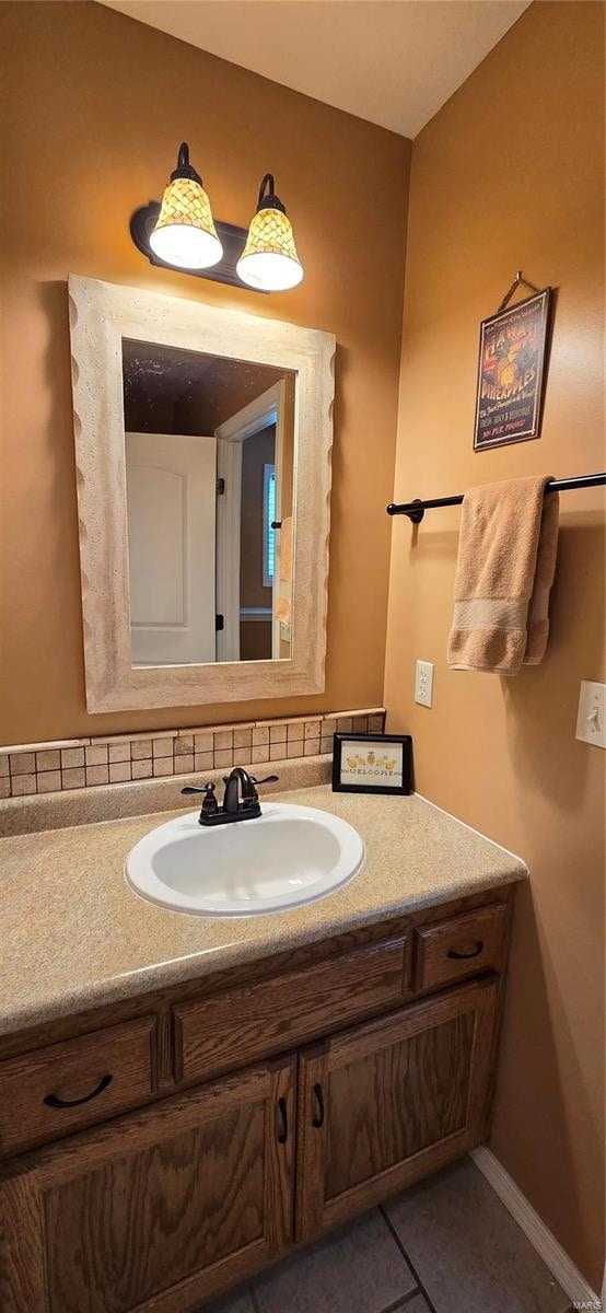 bathroom featuring vanity, backsplash, and tile patterned floors