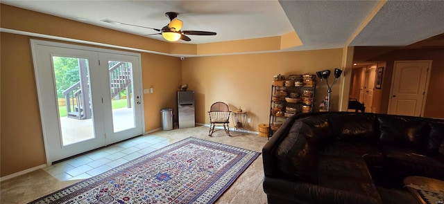 carpeted living room featuring french doors and ceiling fan