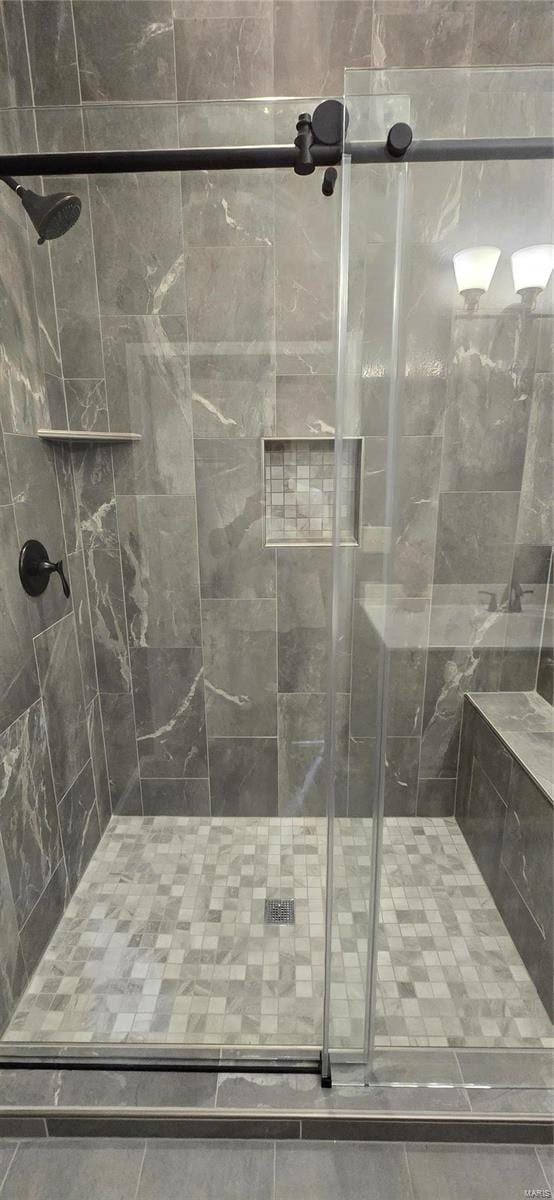 bathroom with a shower with shower door