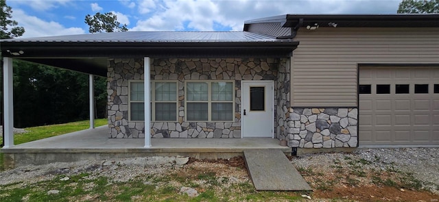 rear view of house featuring a garage