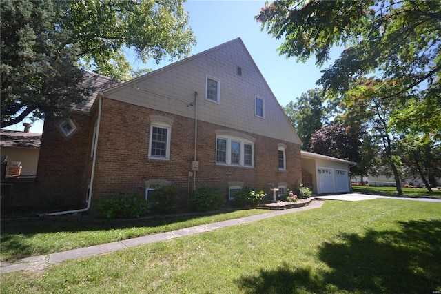 view of home's exterior featuring a lawn and a garage