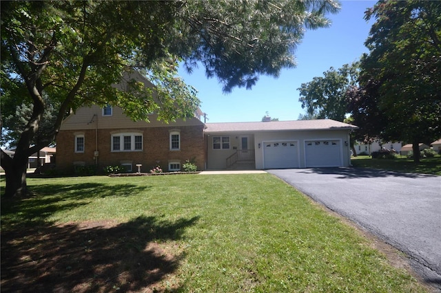 ranch-style house featuring a front lawn and a garage