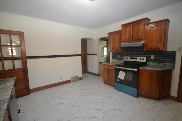 kitchen with backsplash, dark stone countertops, and stainless steel range with electric stovetop