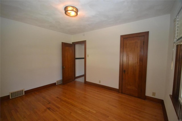 unfurnished bedroom featuring light wood-type flooring