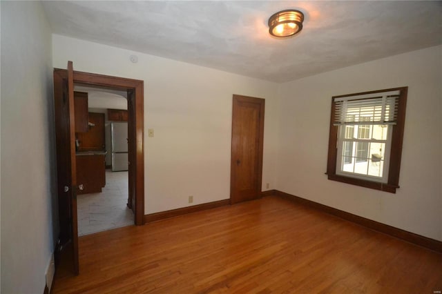 unfurnished room featuring hardwood / wood-style flooring