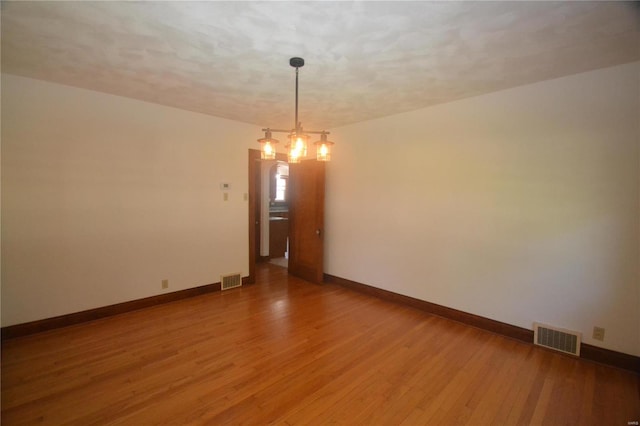 empty room featuring wood-type flooring