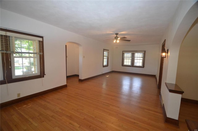 empty room featuring hardwood / wood-style flooring and ceiling fan