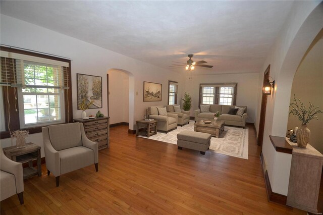 living room featuring ceiling fan and wood-type flooring