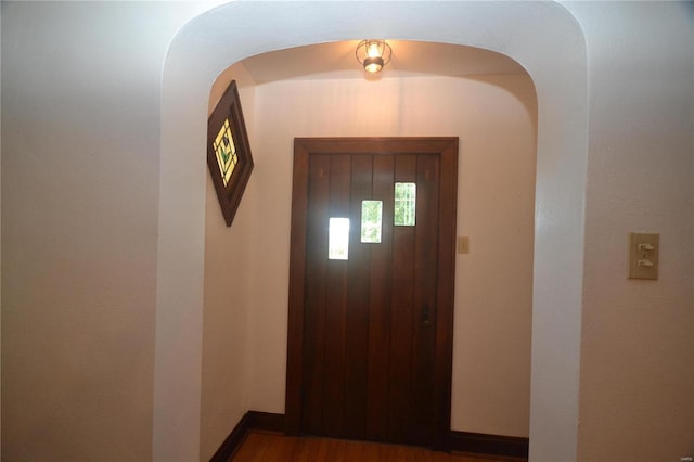 foyer entrance with elevator and dark wood-type flooring