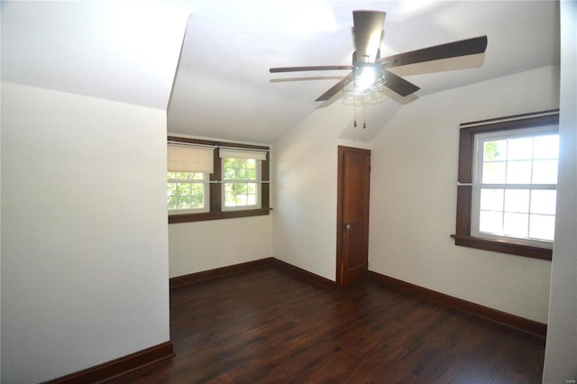 unfurnished room with ceiling fan, dark wood-type flooring, and lofted ceiling