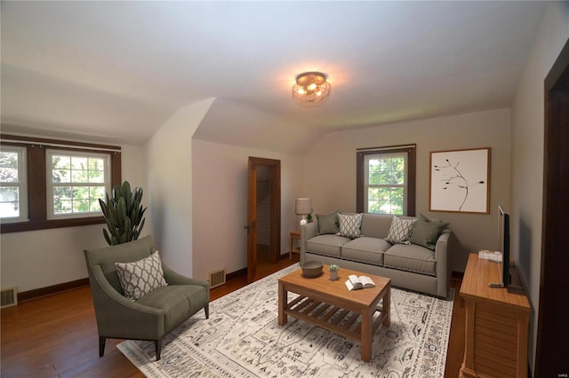 living room featuring hardwood / wood-style floors and vaulted ceiling