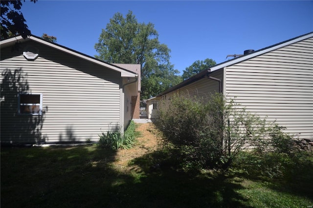 view of home's exterior with a yard