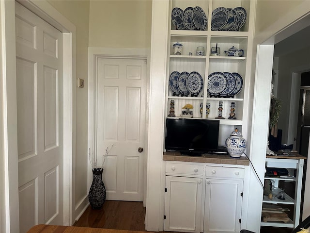 interior space featuring white cabinets and dark wood-type flooring