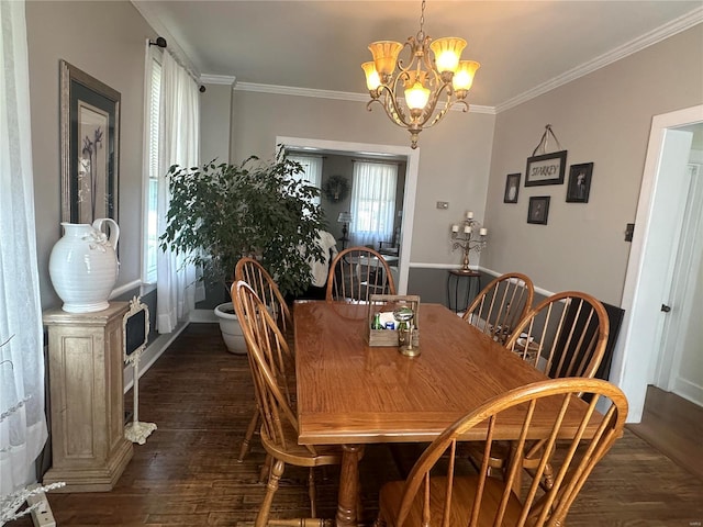 dining area with dark hardwood / wood-style flooring, an inviting chandelier, and ornamental molding