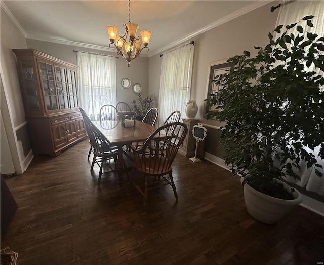 dining room with an inviting chandelier, dark hardwood / wood-style floors, and ornamental molding