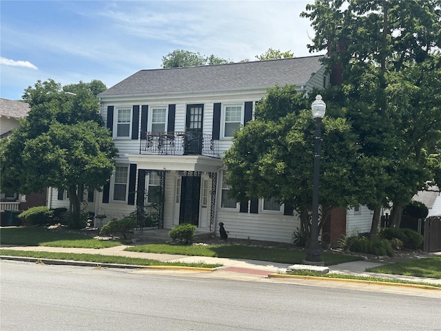 colonial home featuring a balcony