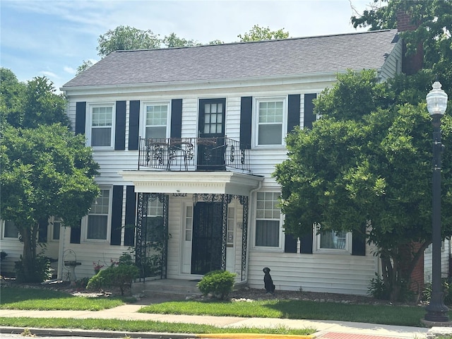 view of front of house featuring a balcony