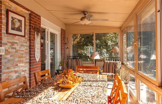 sunroom with ceiling fan and lofted ceiling