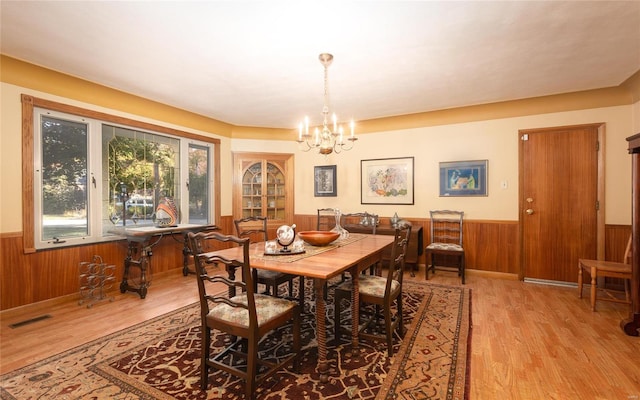 dining room featuring an inviting chandelier and light hardwood / wood-style flooring