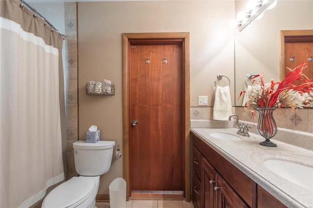 bathroom with tile patterned floors, a shower with curtain, vanity, and toilet