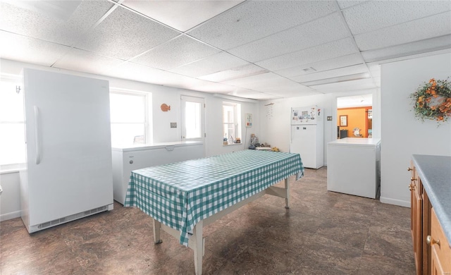 playroom featuring a paneled ceiling and washer / clothes dryer