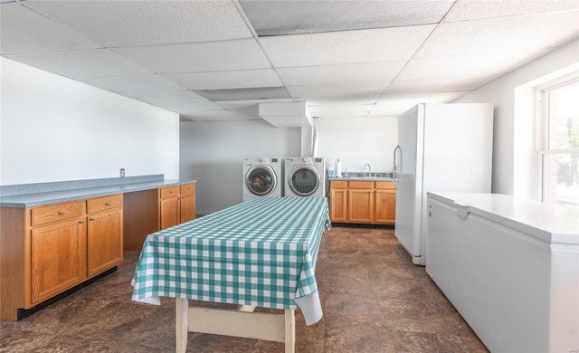 clothes washing area with washer and dryer and sink