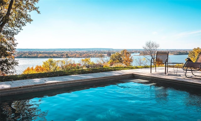 view of swimming pool featuring a water view