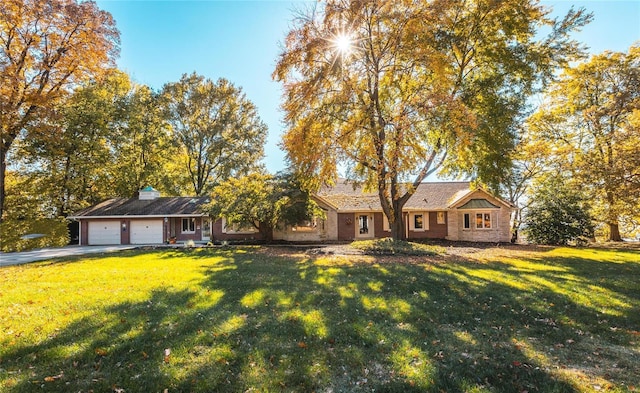 ranch-style house with a garage and a front yard