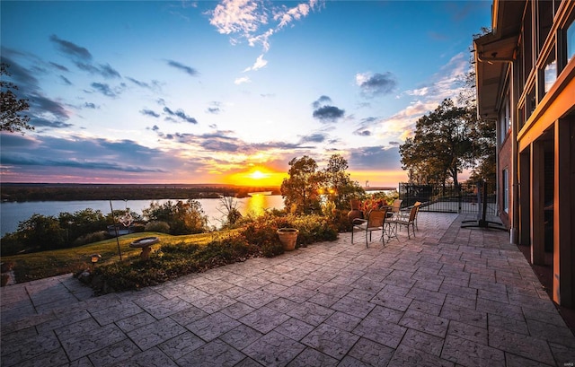 patio terrace at dusk with a water view