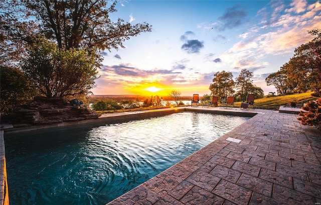 view of pool at dusk