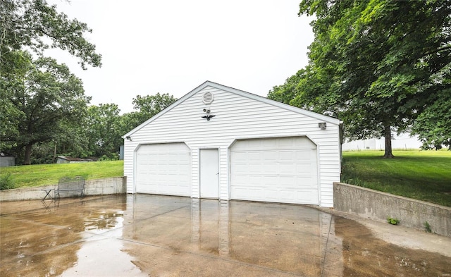 garage featuring a lawn