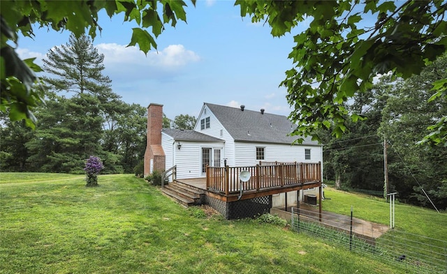 rear view of property with a lawn and a wooden deck