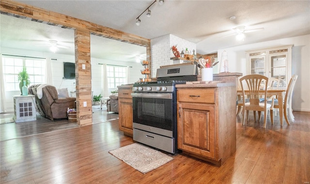 kitchen featuring stainless steel gas stove, plenty of natural light, and a textured ceiling