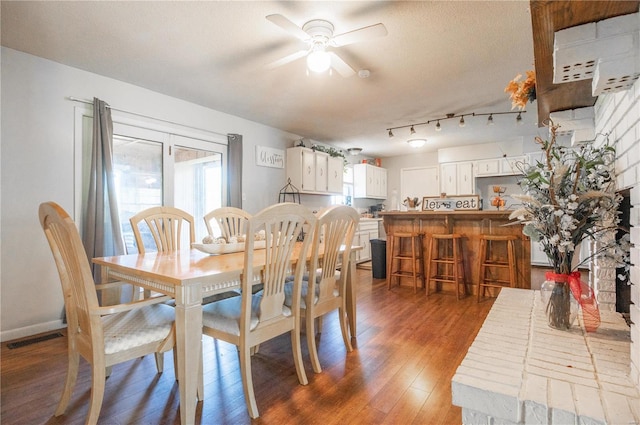 dining area featuring ceiling fan, dark hardwood / wood-style floors, and a textured ceiling