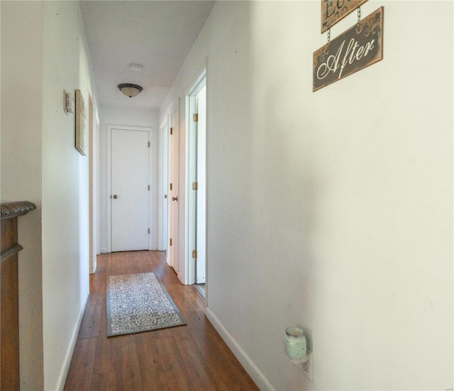 hallway with hardwood / wood-style floors