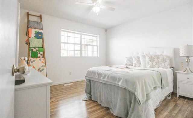 bedroom featuring ceiling fan and dark hardwood / wood-style floors