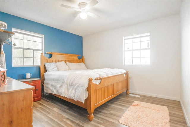 bedroom with ceiling fan and light hardwood / wood-style floors