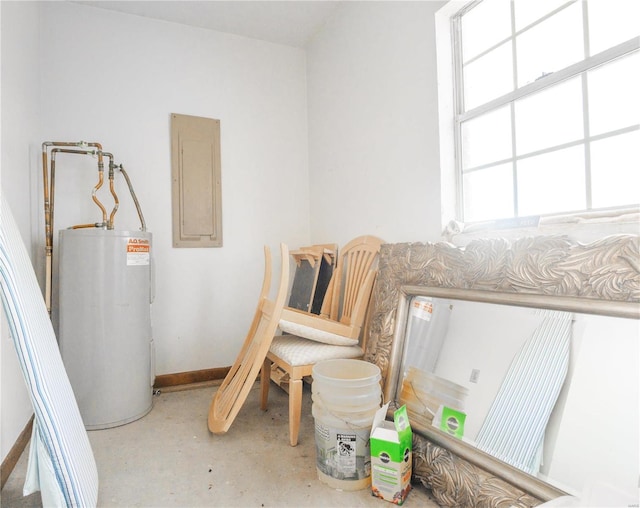 interior space featuring electric water heater, concrete flooring, and electric panel