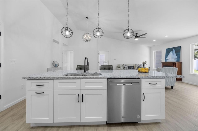 kitchen with white cabinetry, sink, stainless steel dishwasher, and light stone counters