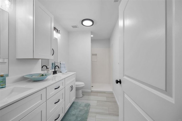 bathroom with walk in shower, vanity, and toilet